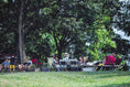 A large group campsite under the trees. 