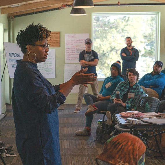 An OEN leader speaking to a large group.